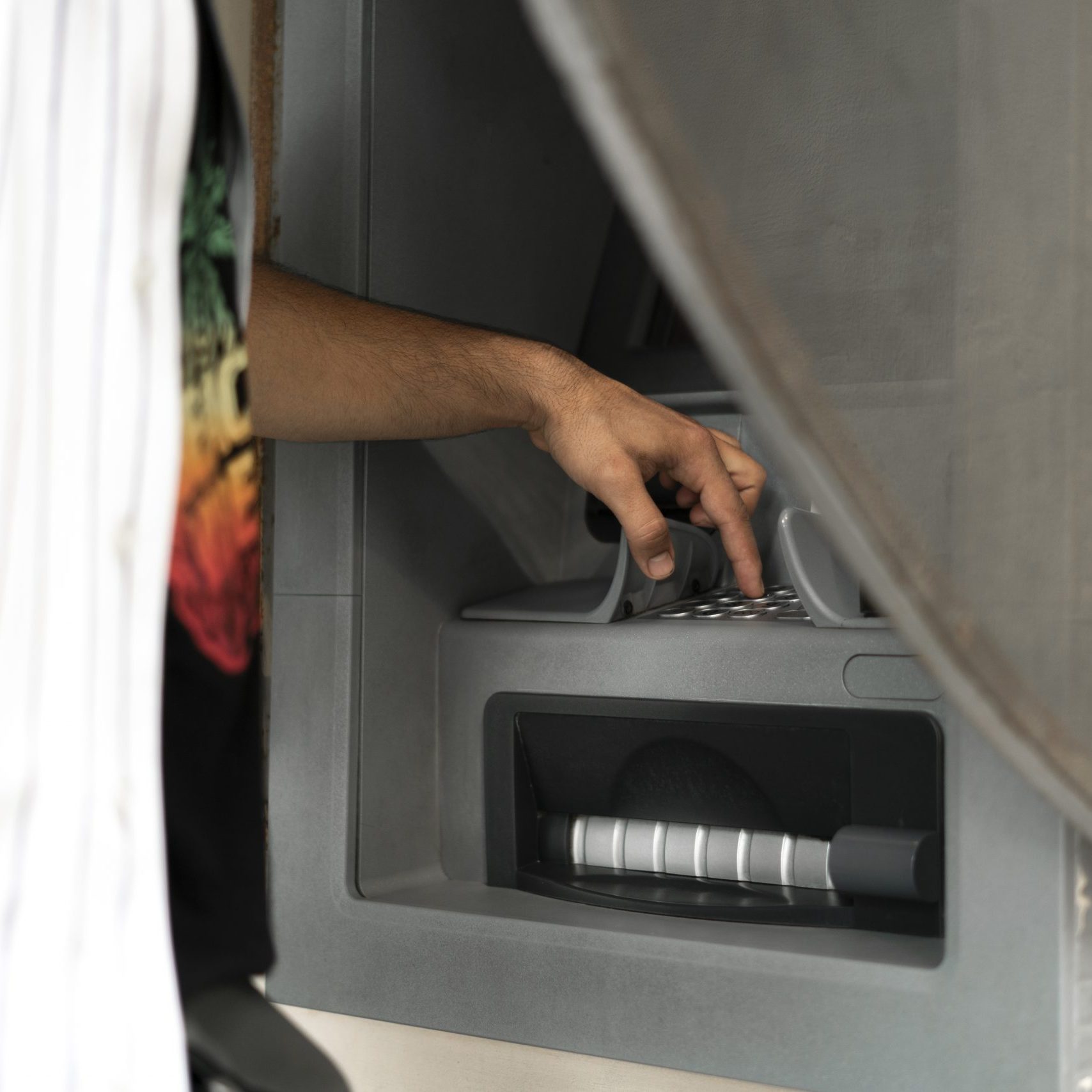 a close up person using ATM to take some cash money from bank card close up person using ATM to take some cash money from bank card