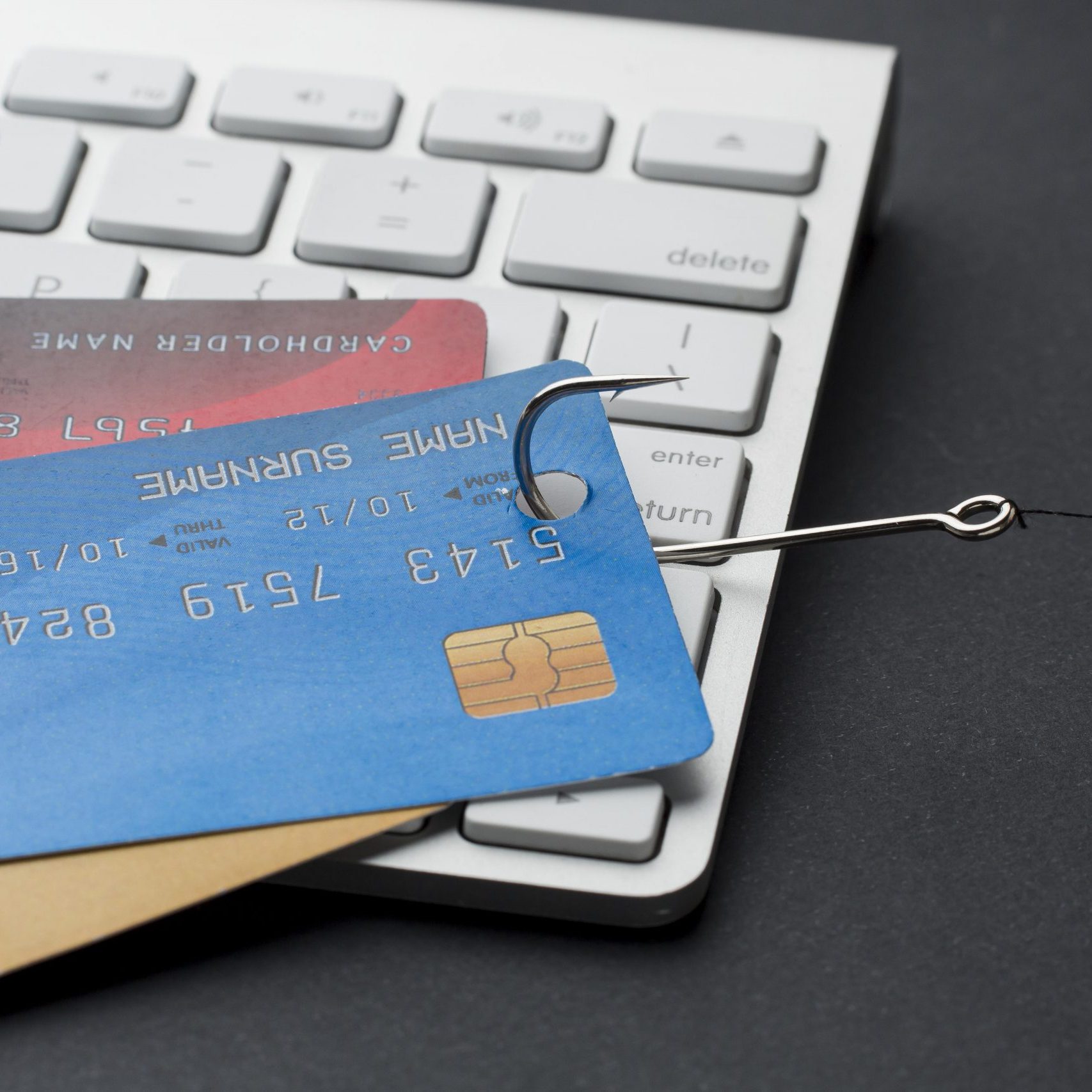 high-angle-keyboard-with-credit-cards-hook-phishing high-angle-keyboard-with-credit-cards-hook-phishing